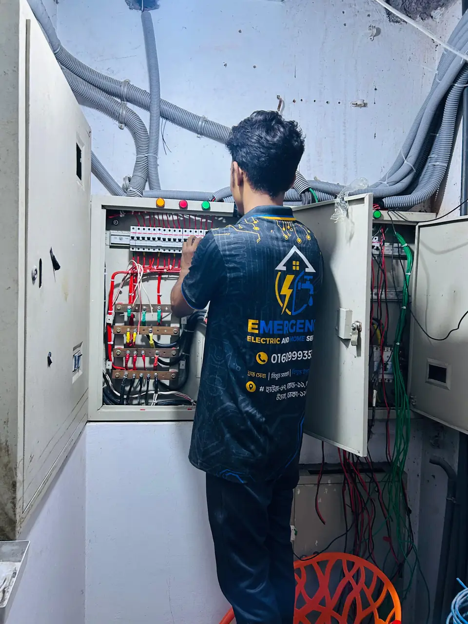 Engineer servicing a large main distribution board in a commercial building